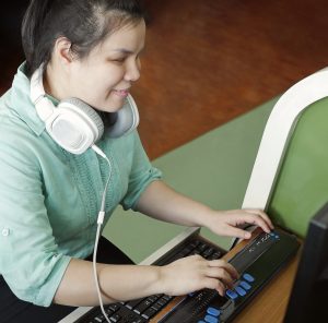 Asian,Young,Blind,Person,Woman,With,Headphone,Using,Computer,With